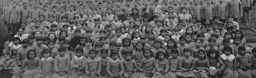 
After the Dawes Act was passed in 1887, Congress ignored the
'establishment clause' separating church from state and turned
federal Indian policy over to Christian missionaries.&nbsp; For the
next fifty years, Indian children were abducted from their homes on
Indian reservations by Christian missionaries and federal agents
and taken to schools thousands of miles away where it was hoped
education in the white man's world would assimilate native people
into mainstream society.&nbsp; Thousands of Indian children died at
the schools, or disappeared after running away and trying to find
their way back home.&nbsp; Here, Indian children pose for a group
portrait at the Carlisle Indian School in Pennsylvania.
